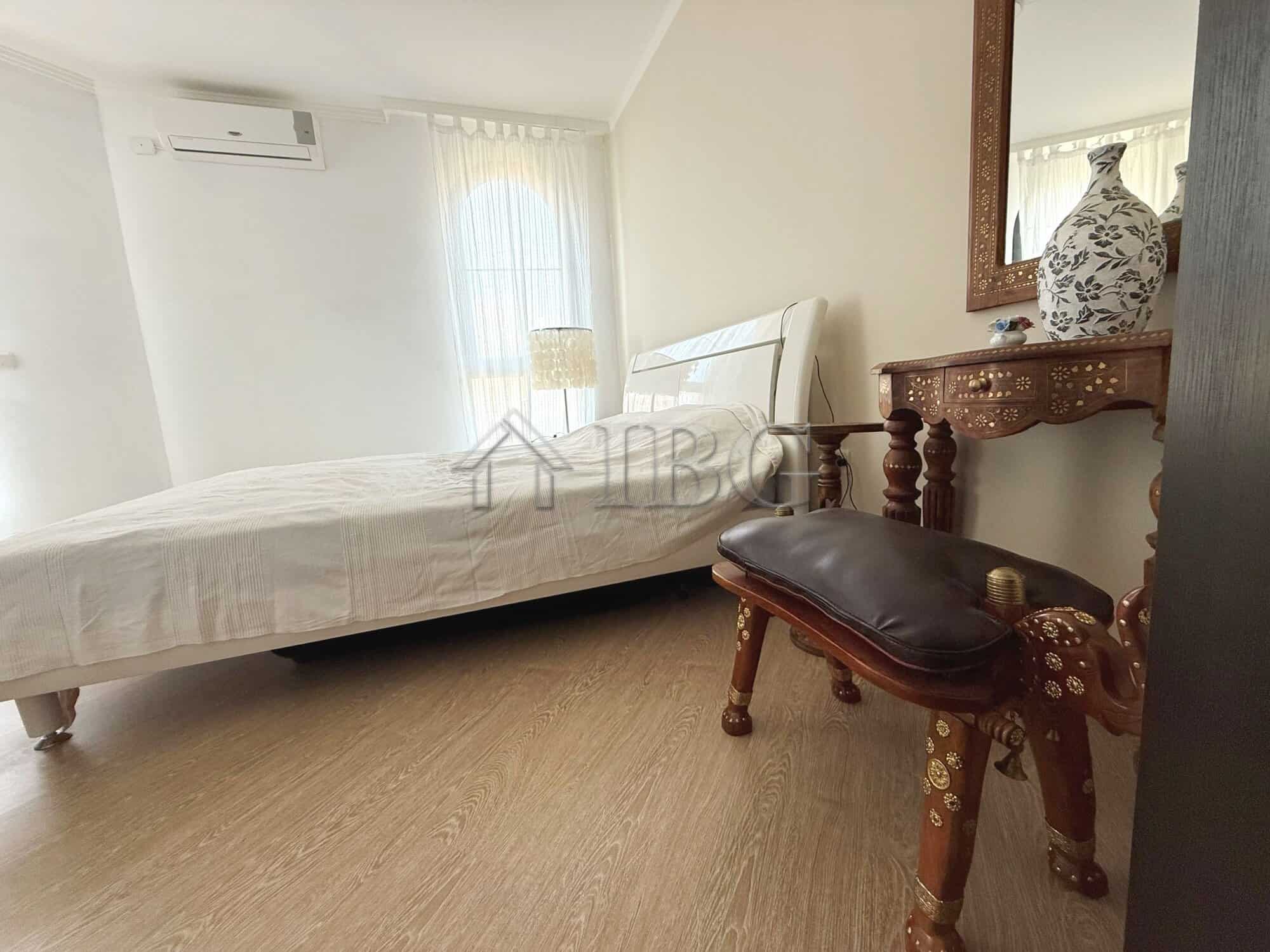 Bedroom with large terrace, bright window, and elegant furniture in Sveti Vlas apartment.