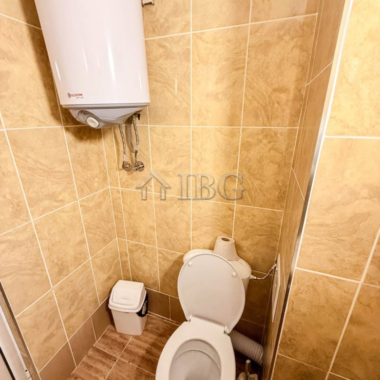 Storage room with toilet, water heater, and water supply system in a small space.