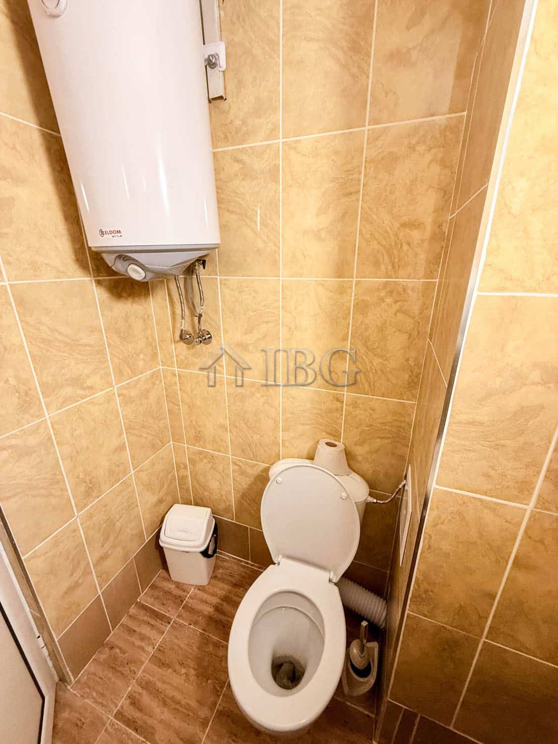 Storage room with toilet, water heater, and water supply system in a small space.