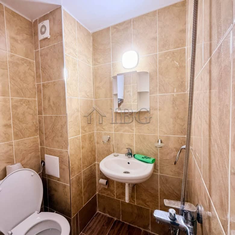 Compact bathroom with toilet, sink, and shower in Summer Ravda. Essential utilities included for com.