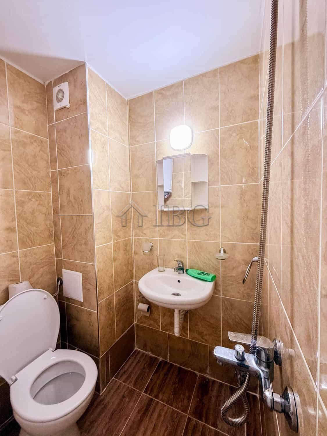 Compact bathroom with toilet, sink, and shower in Summer Ravda. Essential utilities included for com.