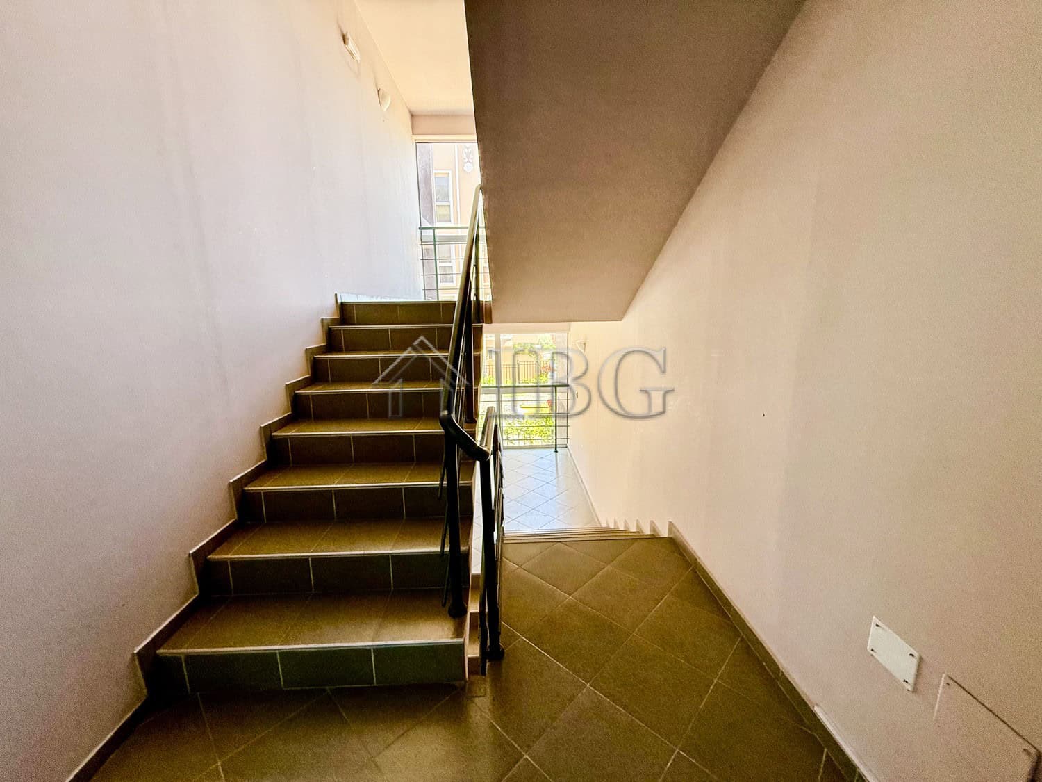 Interior view of a storage studio in Summer Ravda, showing stairs and utility access points.