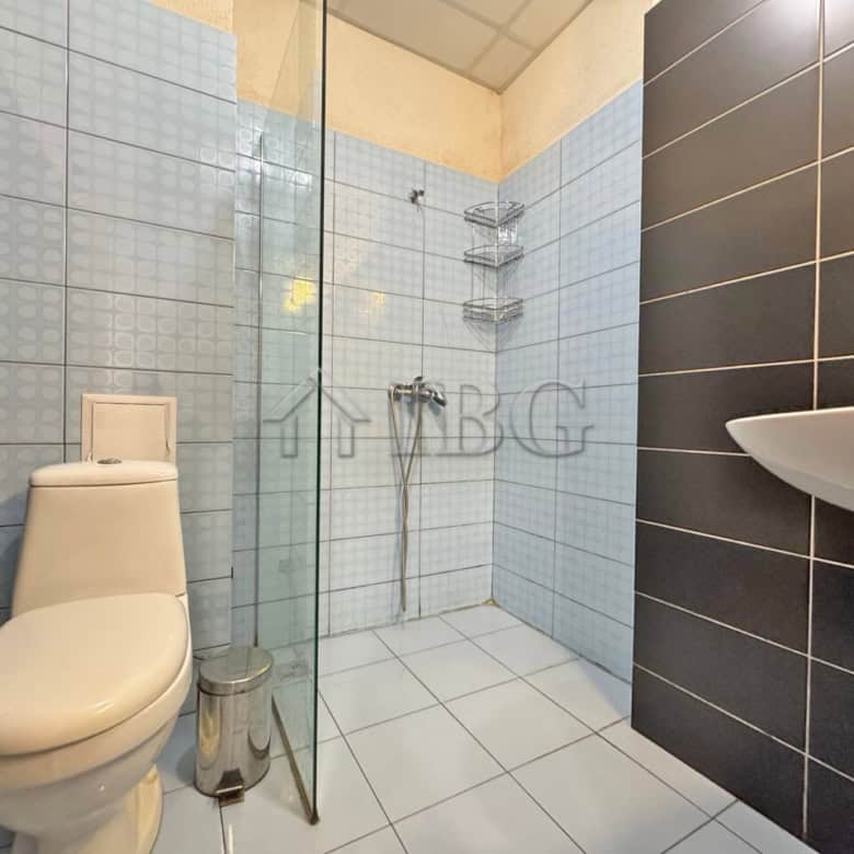 Bright bathroom in a studio apartment with balcony overlooking the pool in Sunny View Central.