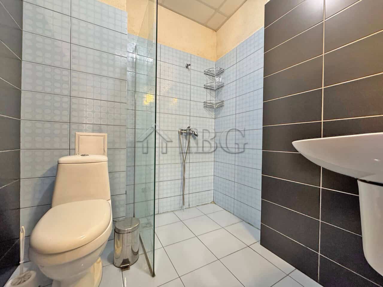 Bright bathroom in a studio apartment with balcony overlooking the pool in Sunny View Central.