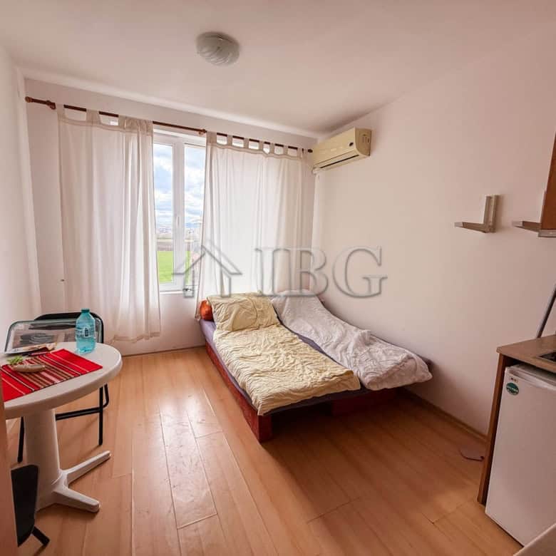 Small studio apartment for sale with a sea view, bright interior, and modern furnishings.
