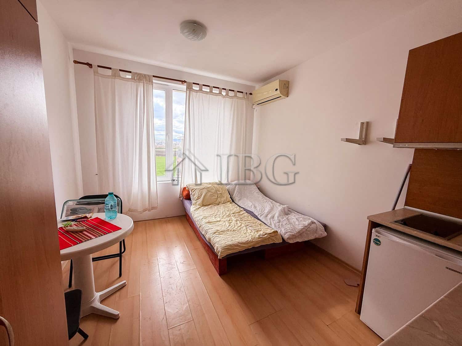 Small studio apartment for sale with a sea view, bright interior, and modern furnishings.