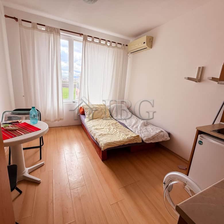 Bright studio apartment with a large window and natural light in Sunny Beach.