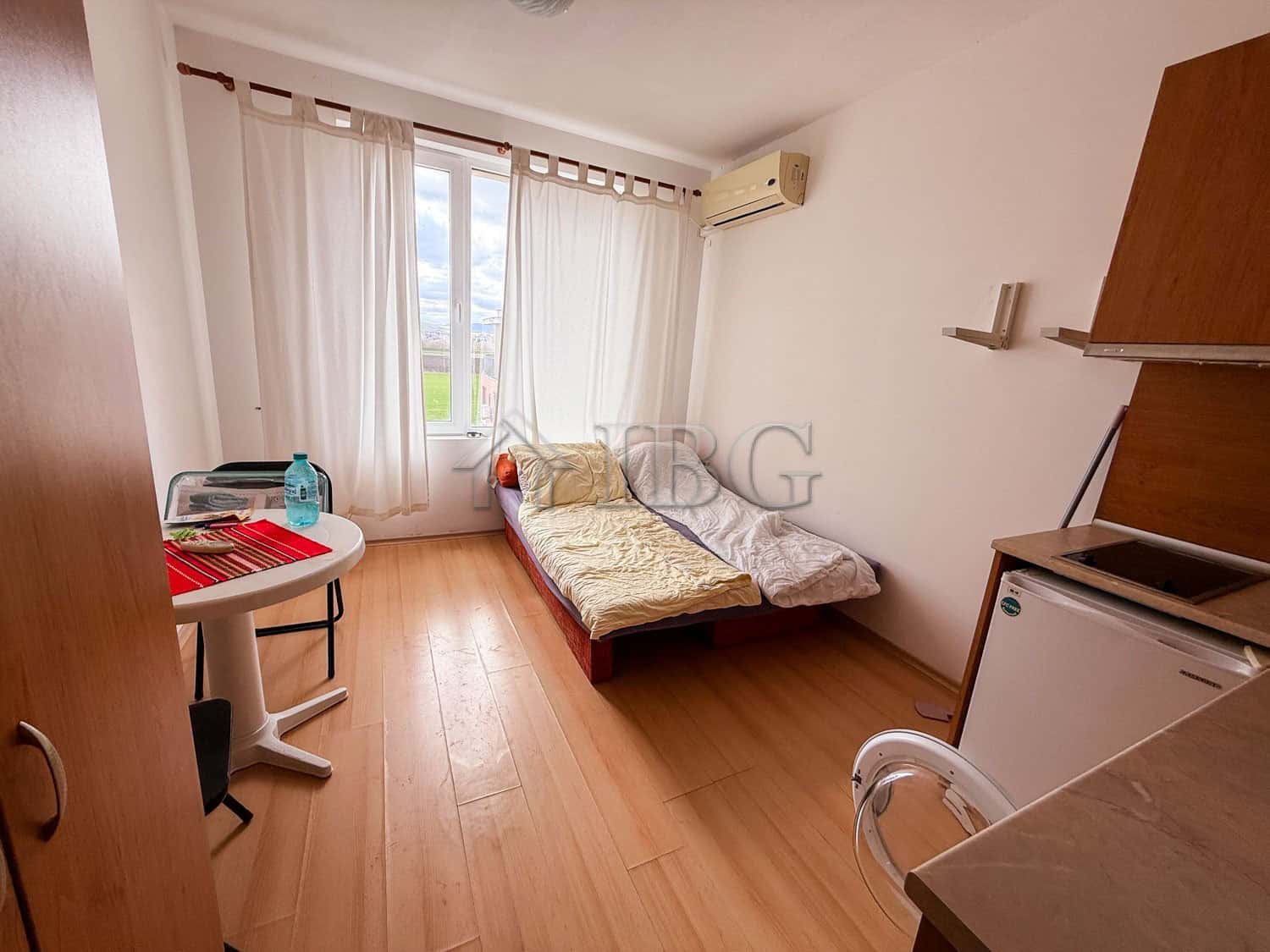 Bright studio apartment with a large window and natural light in Sunny Beach.