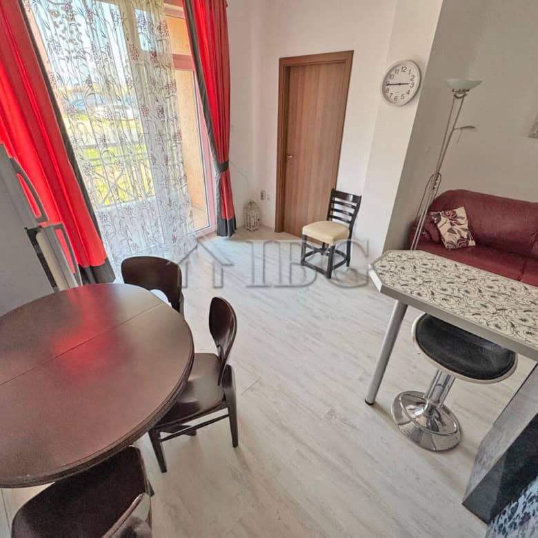 Interior view of a ground-floor apartment with living room, dining area, and balcony in Sunny Beach.