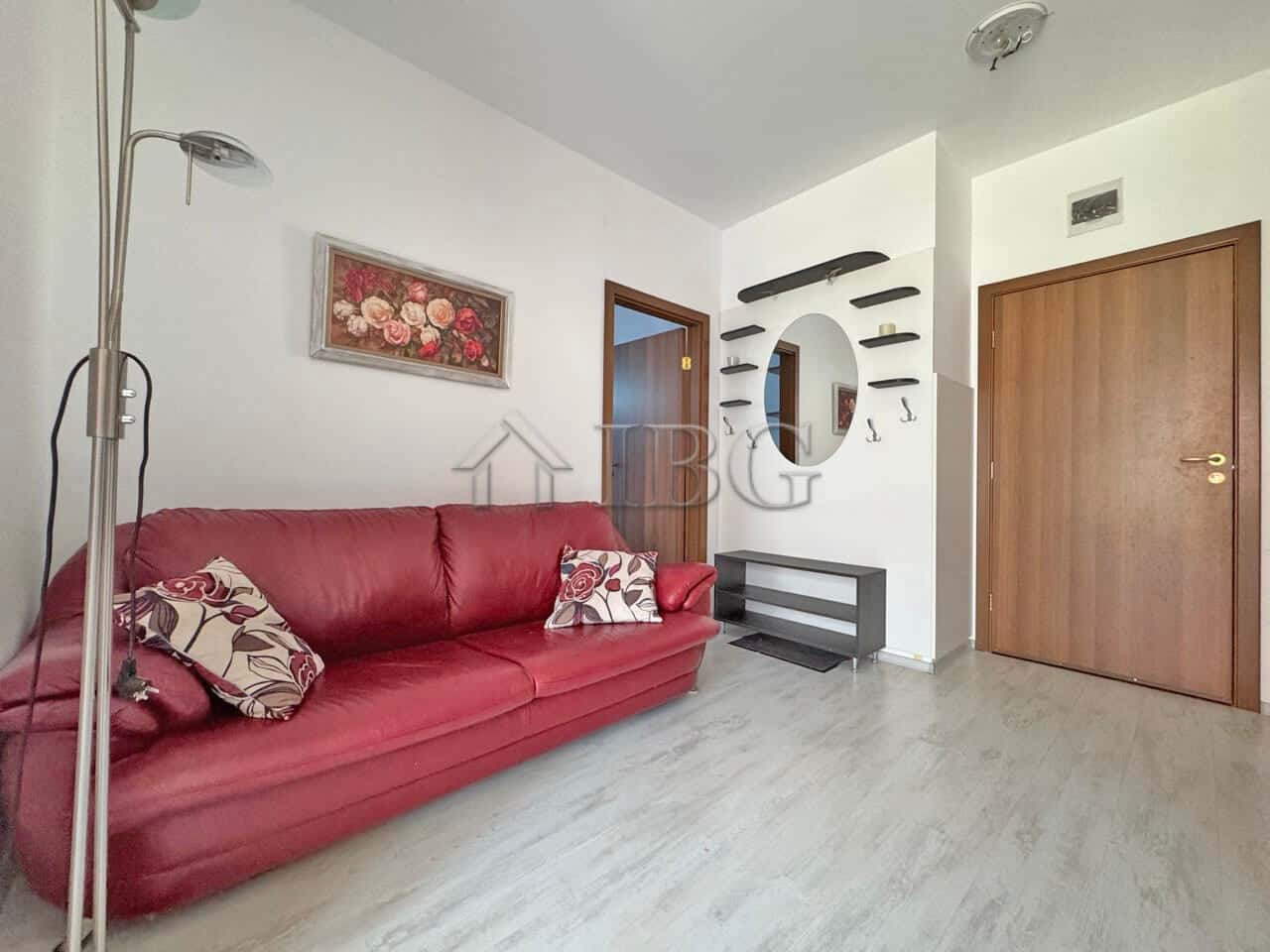 Bright living room with red sofa and modern decor in Sunny Day 6, Sunny Beach.