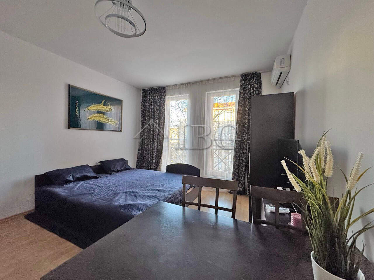 Bright studio apartment with modern furnishings, large windows, and a cozy atmosphere close to Sunny.