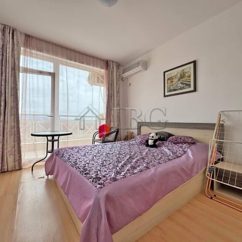 Bright 1-bedroom apartment with balcony overlooking sunny beach and panoramic sea views.