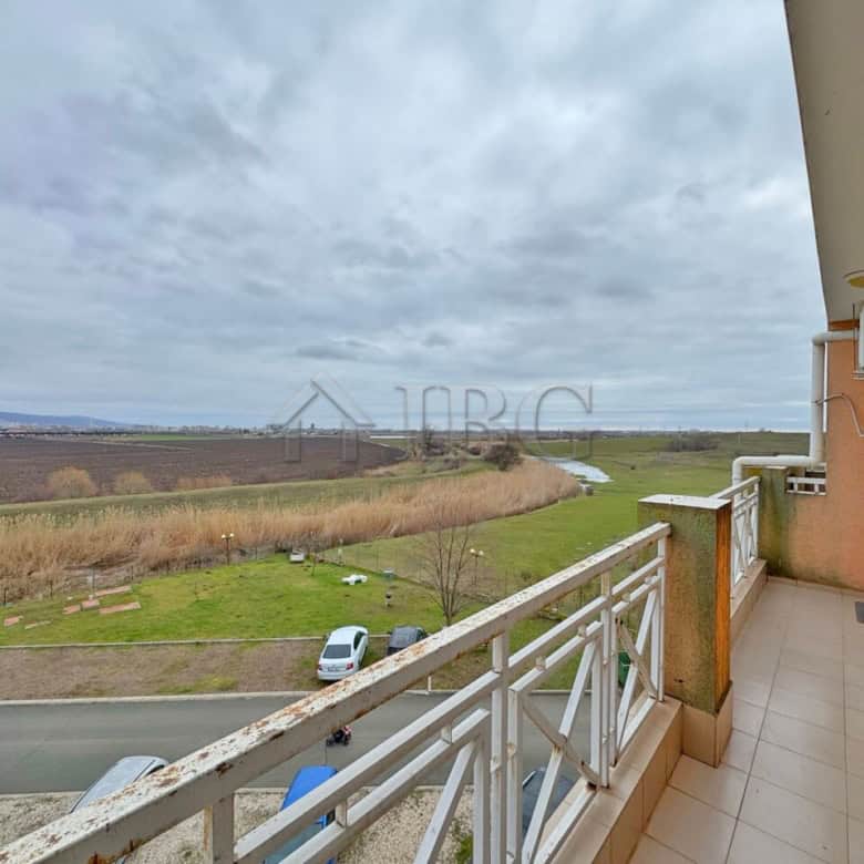 Spacious balcony overlooking lush landscape and open skies, perfect for relaxing and enjoying panora.