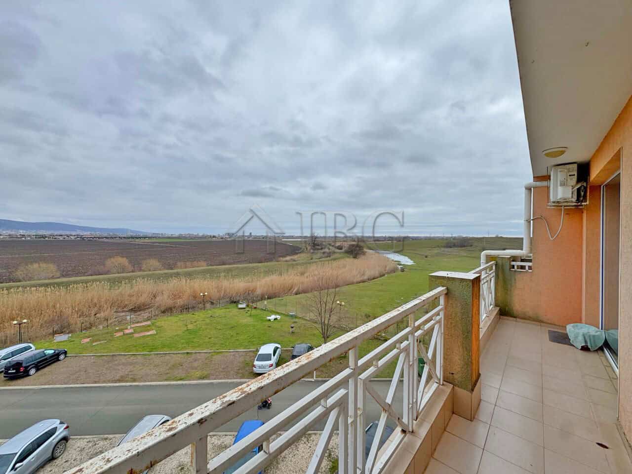 Spacious balcony overlooking lush landscape and open skies, perfect for relaxing and enjoying panora.