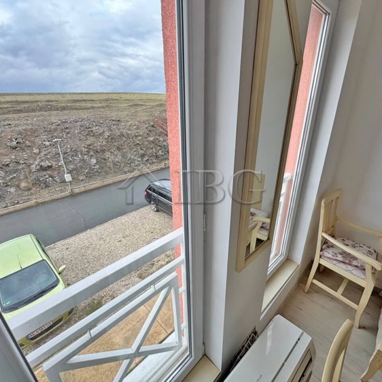 Bright furnished studio with large windows overlooking the outdoor scenery.