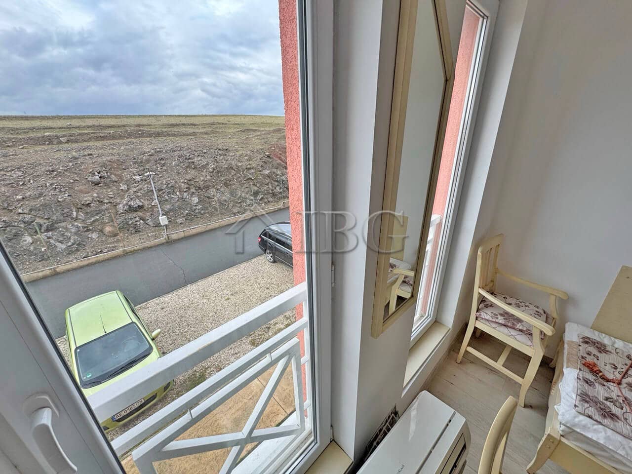 Bright furnished studio with large windows overlooking the outdoor scenery.