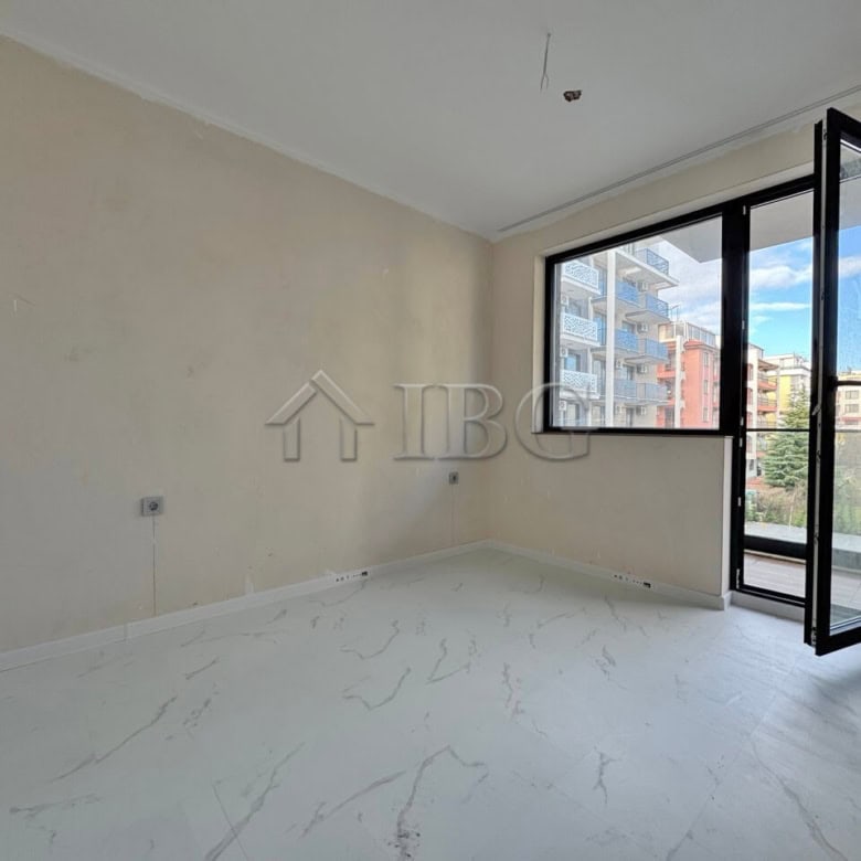 Apartment with spacious living area, large window, and balcony in Sunny Beach.