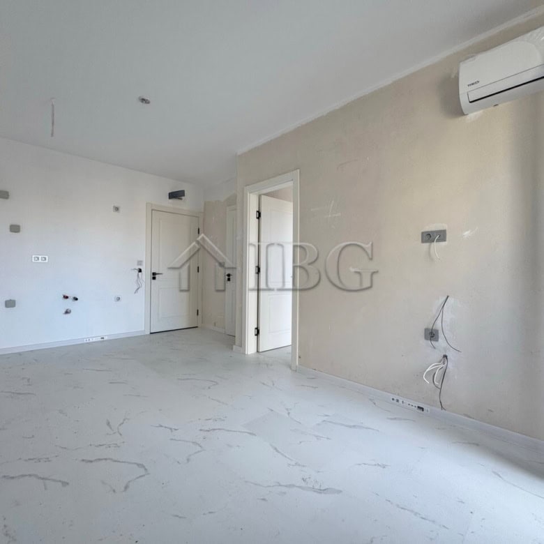 Bright, unfurnished one-bedroom apartment in Sunny Beach with large windows and air conditioning.