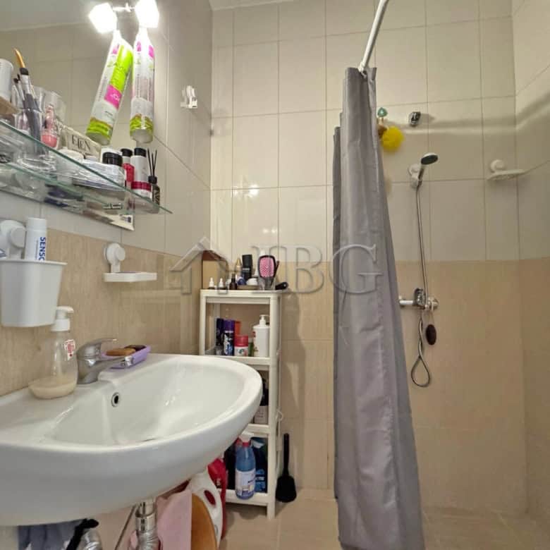 Compact bathroom with shower, sink, and storage in Topoli Complex, Sunny Beach.