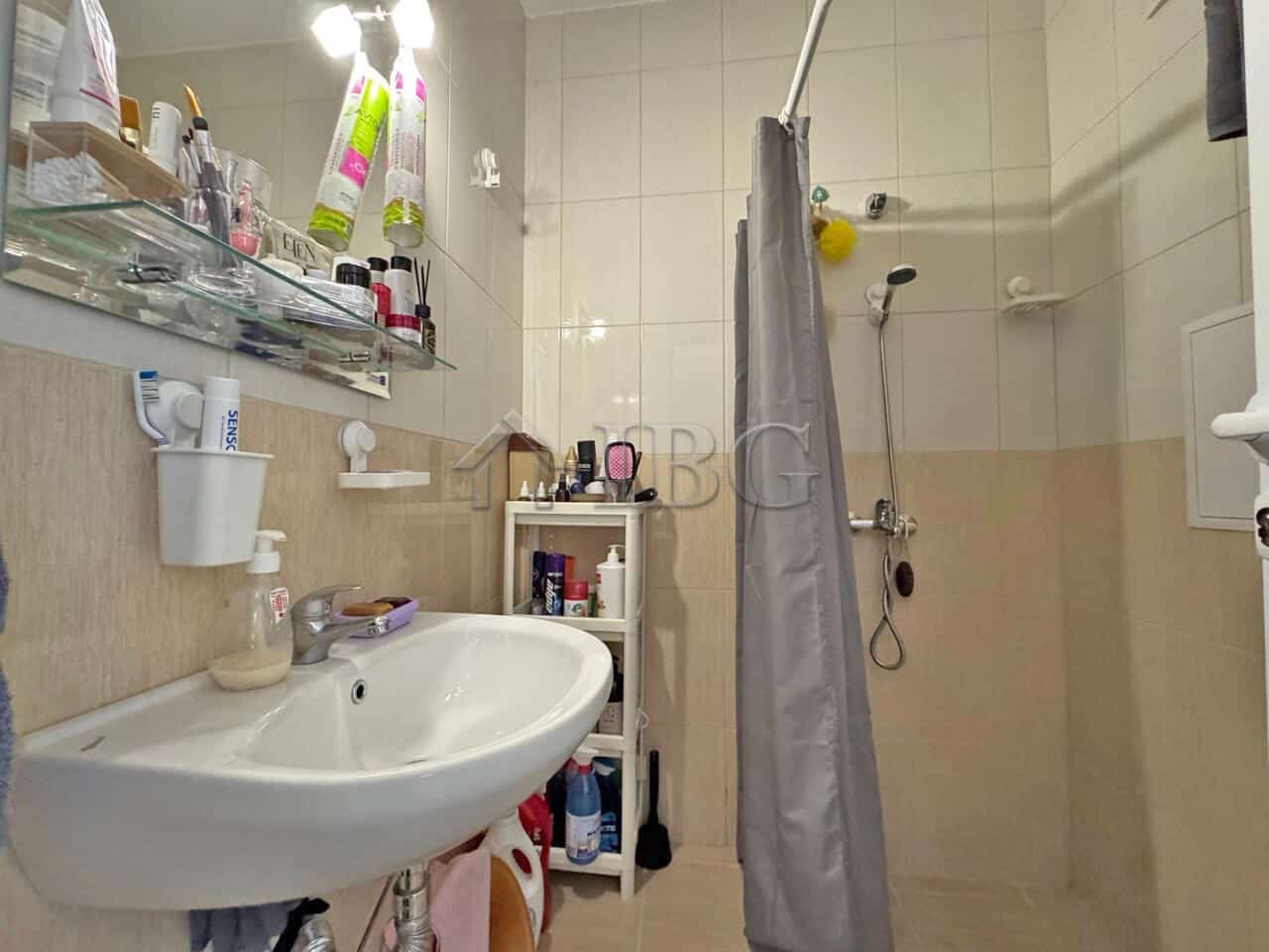 Compact bathroom with shower, sink, and storage in Topoli Complex, Sunny Beach.