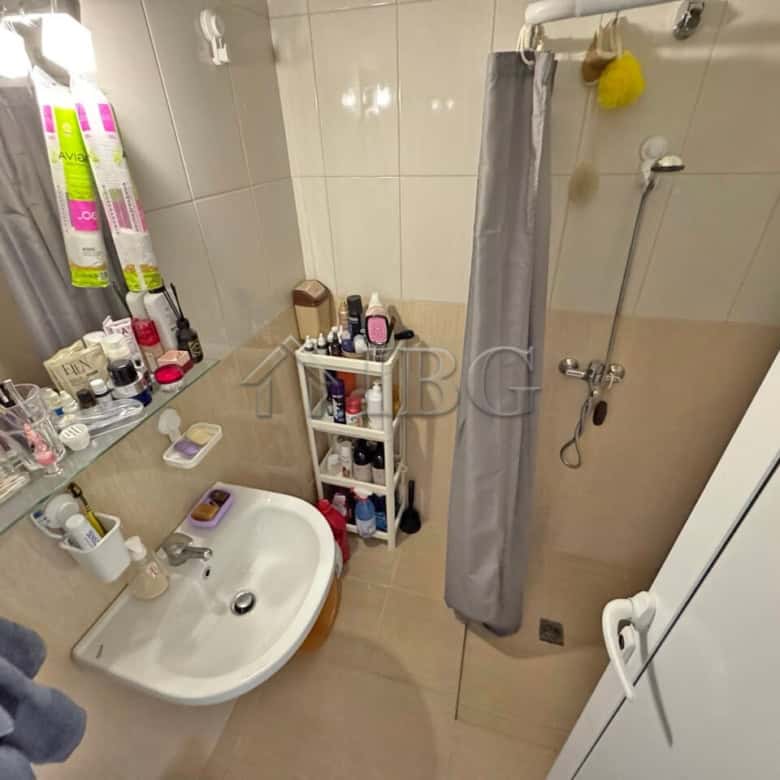 Furnished studio bathroom with shower, toiletries, and storage in Topoli Complex, Sunny Beach.