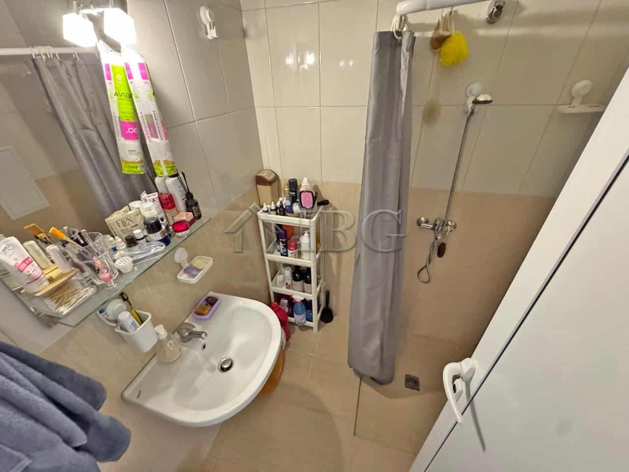Furnished studio bathroom with shower, toiletries, and storage in Topoli Complex, Sunny Beach.