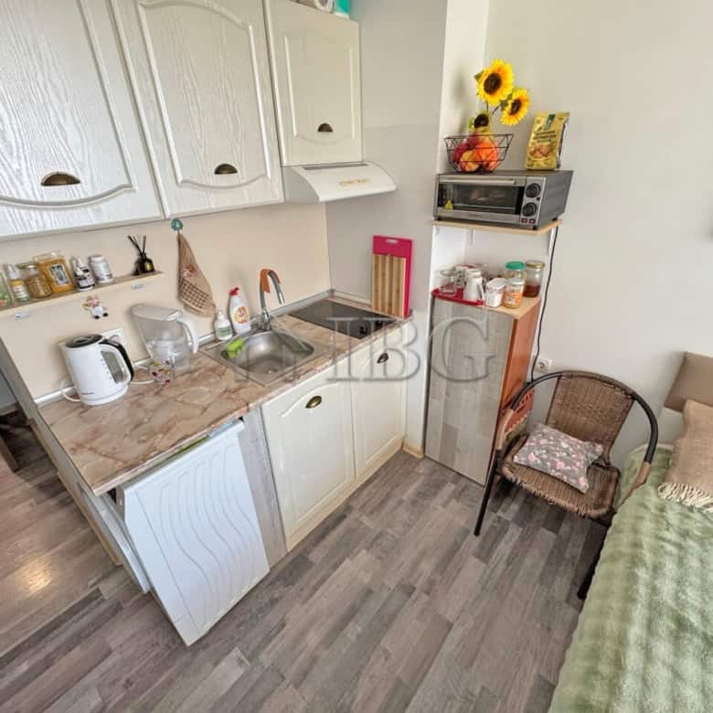 Furnished studio apartment with balcony in Sunny Beach, Bulgaria, featuring a compact kitchen and co.
