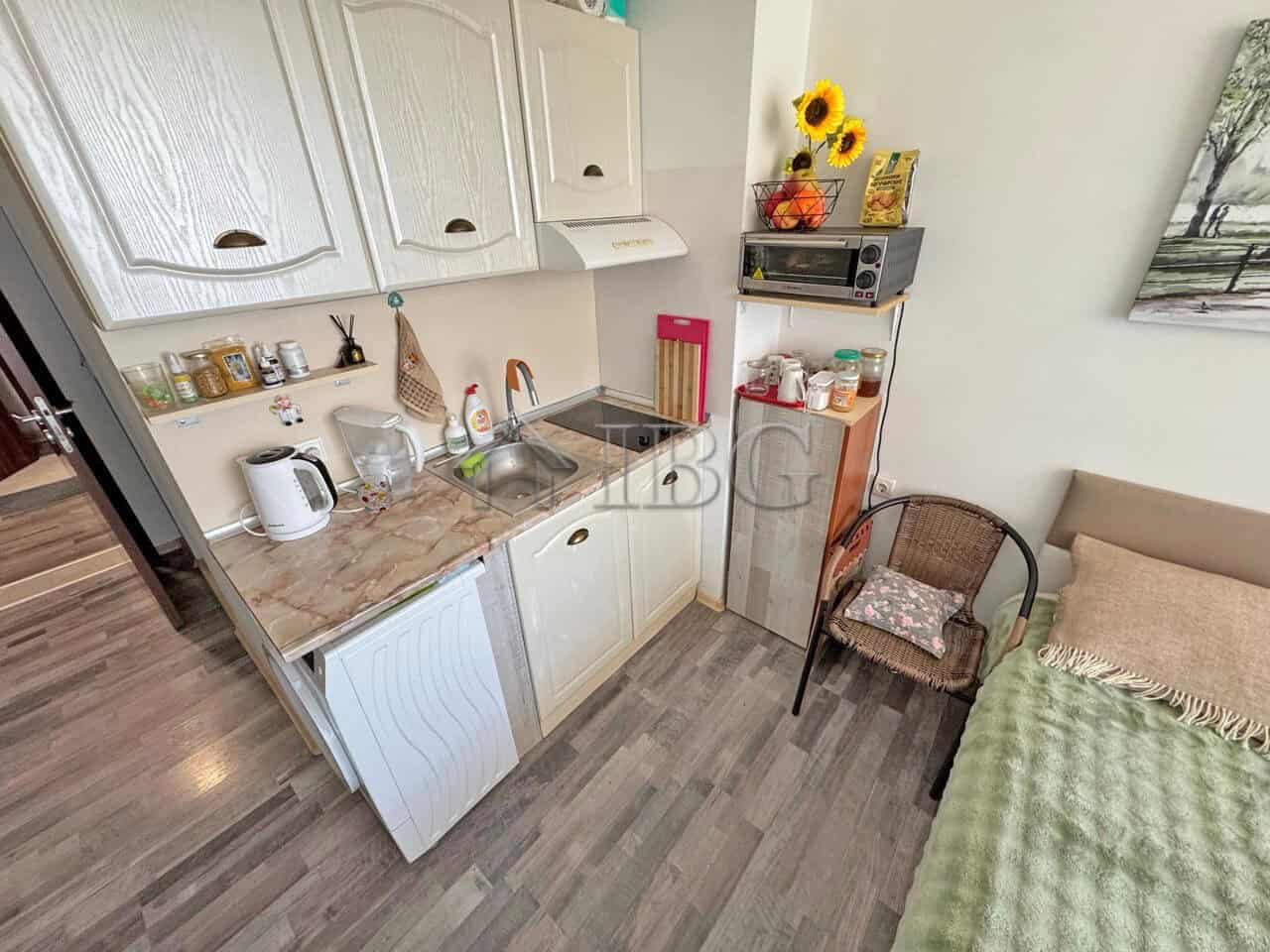 Furnished studio apartment with balcony in Sunny Beach, Bulgaria, featuring a compact kitchen and co.