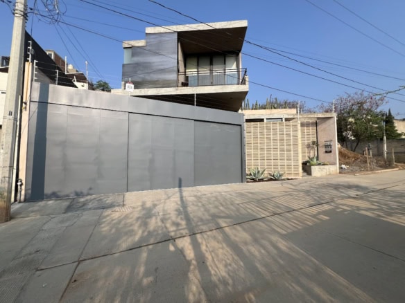 Modern contemporary house with sleek design and large balcony.