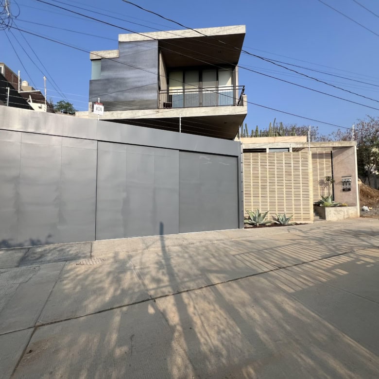 Modern contemporary house with sleek design and large balcony.