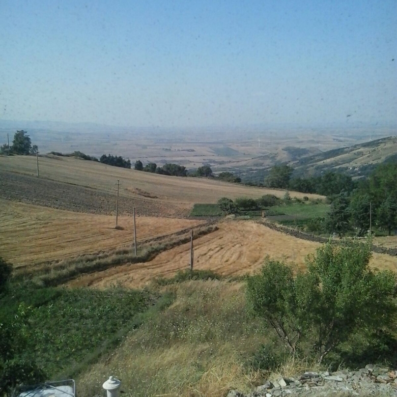 Scenic view of rolling hills and farmland in Orsara di Puglia, Italy, ideal for countryside living o.