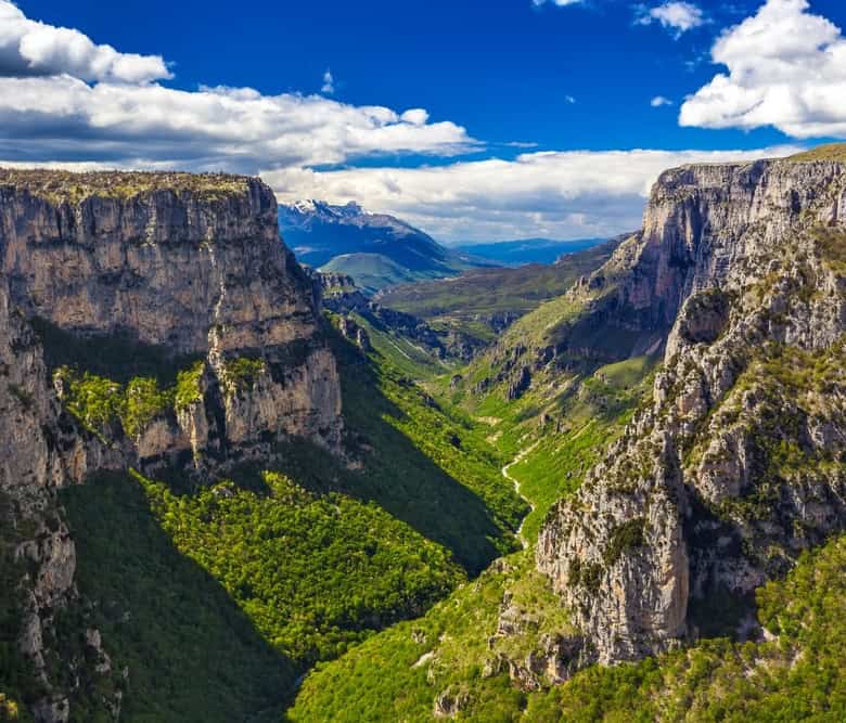 Scenic view of Vitsa Zagori with lush green valley and towering cliffs in Greece. Perfect for land i.