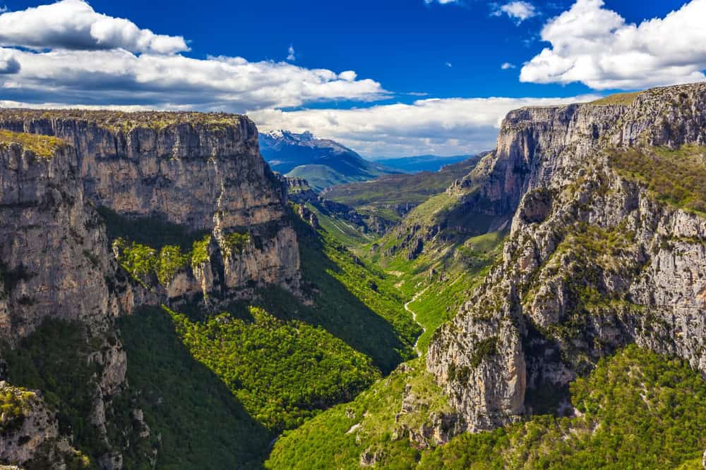 Scenic view of Vitsa Zagori with lush green valley and towering cliffs in Greece. Perfect for land i.