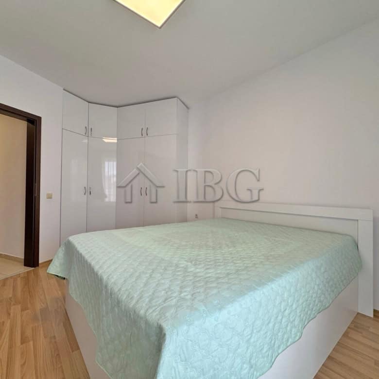 Modern one-bedroom apartment with pool view in Sunny Beach, featuring a bright bedroom and built-in.