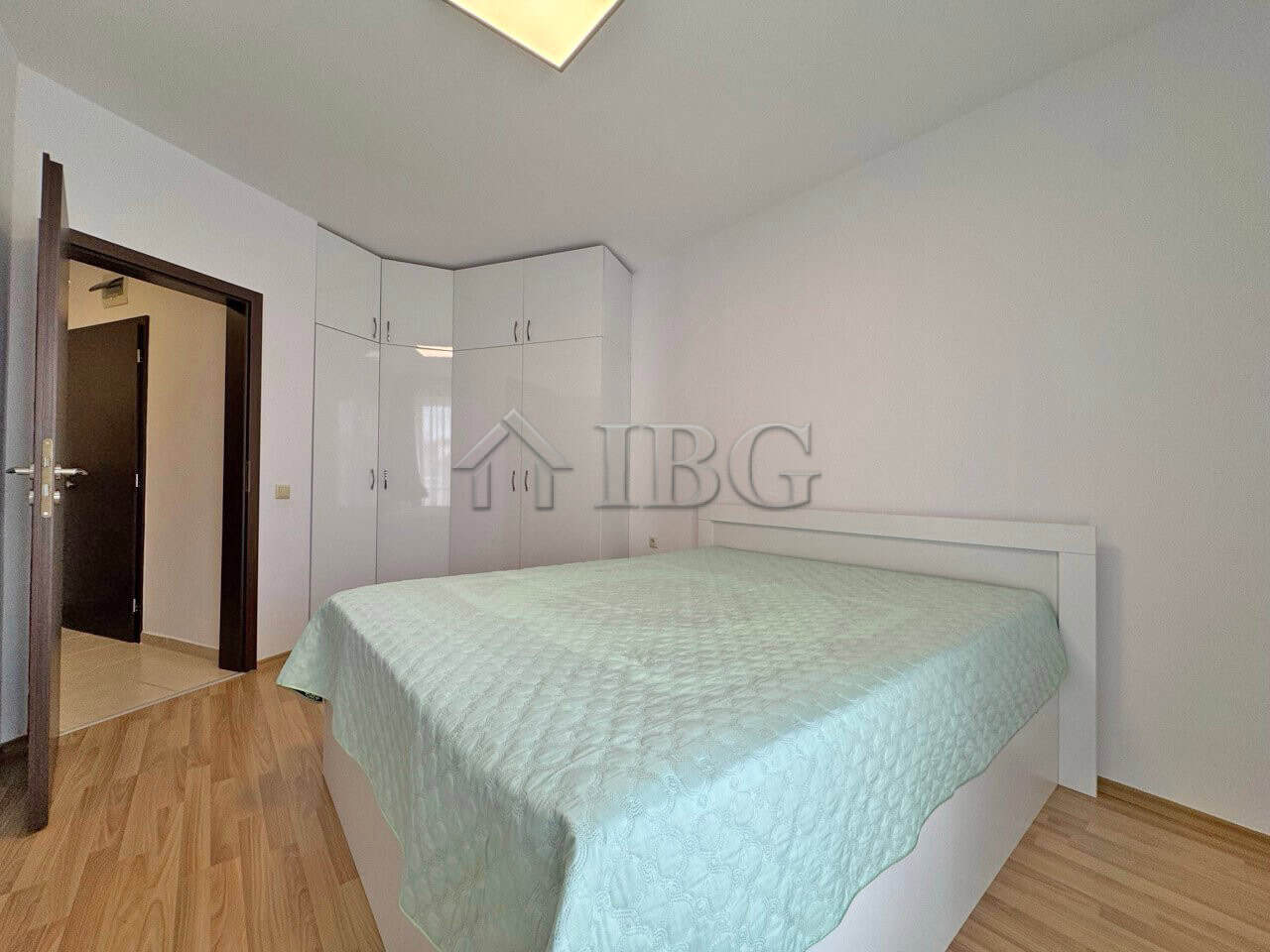Modern one-bedroom apartment with pool view in Sunny Beach, featuring a bright bedroom and built-in.