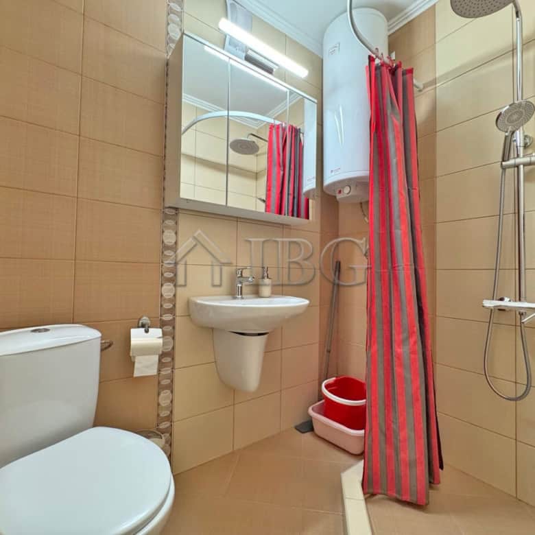 Bright bathroom with shower and modern fixtures in a sunny beach apartment.