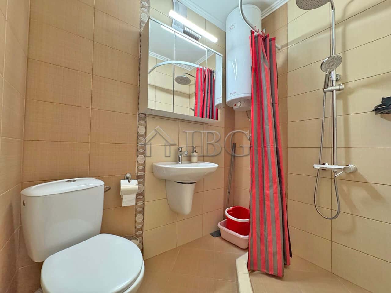 Bright bathroom with shower and modern fixtures in a sunny beach apartment.