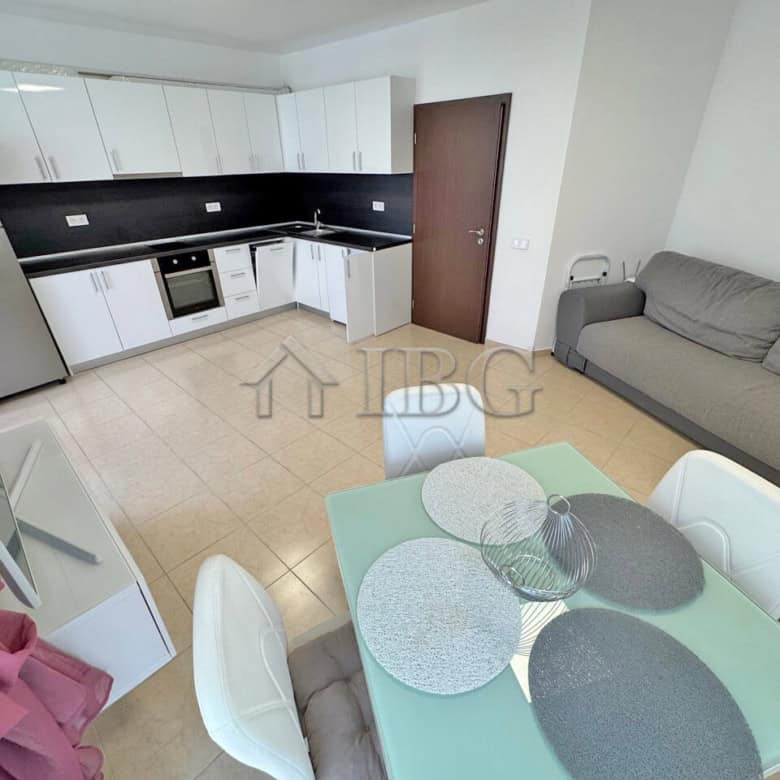 Modern one-bedroom apartment with a pool view, open-plan kitchen, and cozy living area in Sunny Beac.