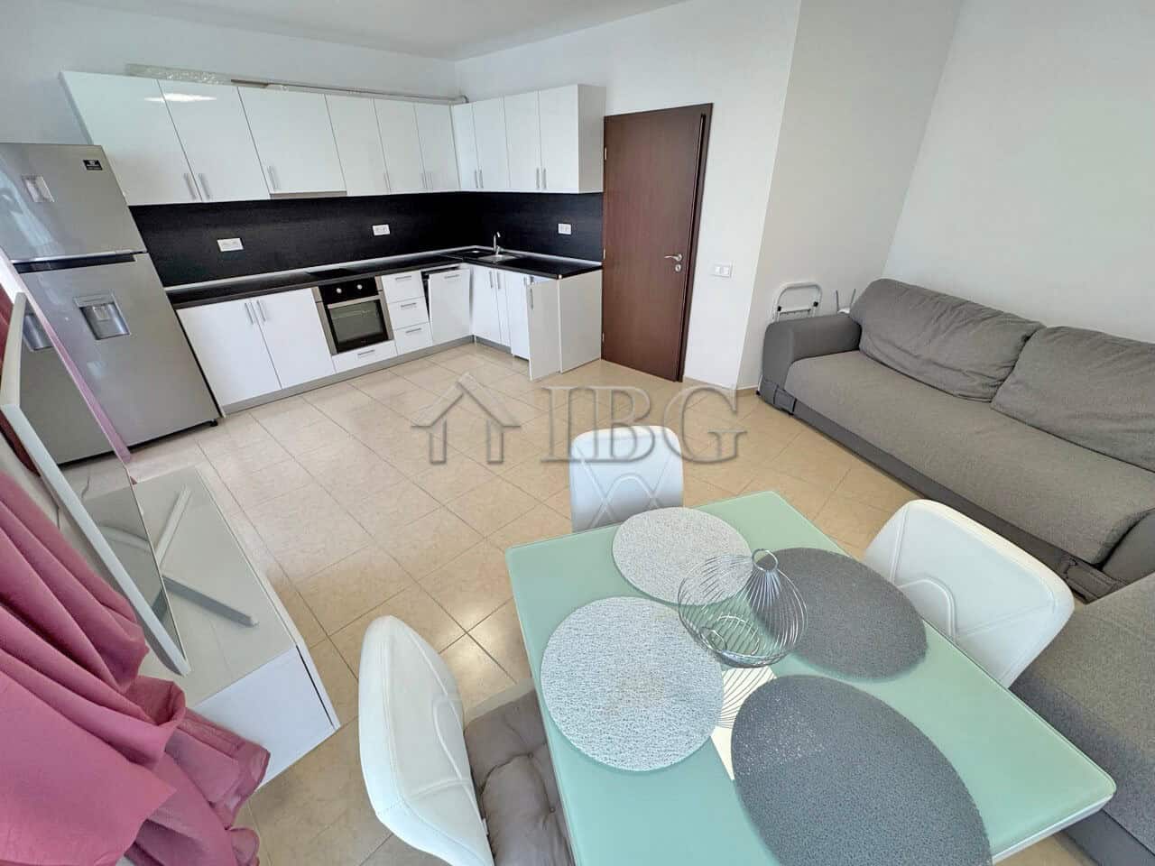 Modern one-bedroom apartment with a pool view, open-plan kitchen, and cozy living area in Sunny Beac.