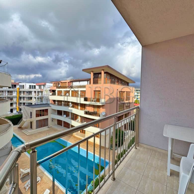 Comfortable apartment overlooking the pool with balcony and seating area.