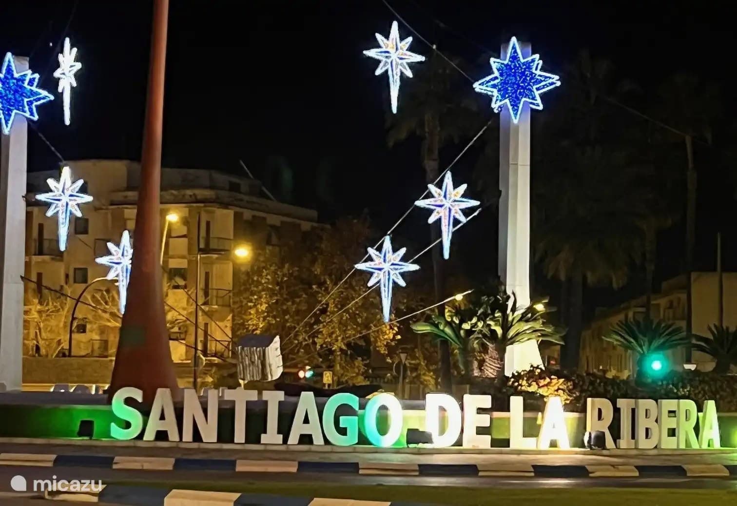 Bright night view of Santiago de la Ribera with illuminated stars and welcoming atmosphere.