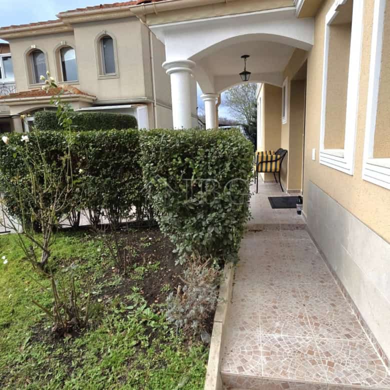 Elegant villa entrance with lush greenery and classic architecture in Pomorie.